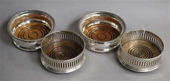 Two pairs of modern silver mounted wine coasters, largest diameter 10.5cm.